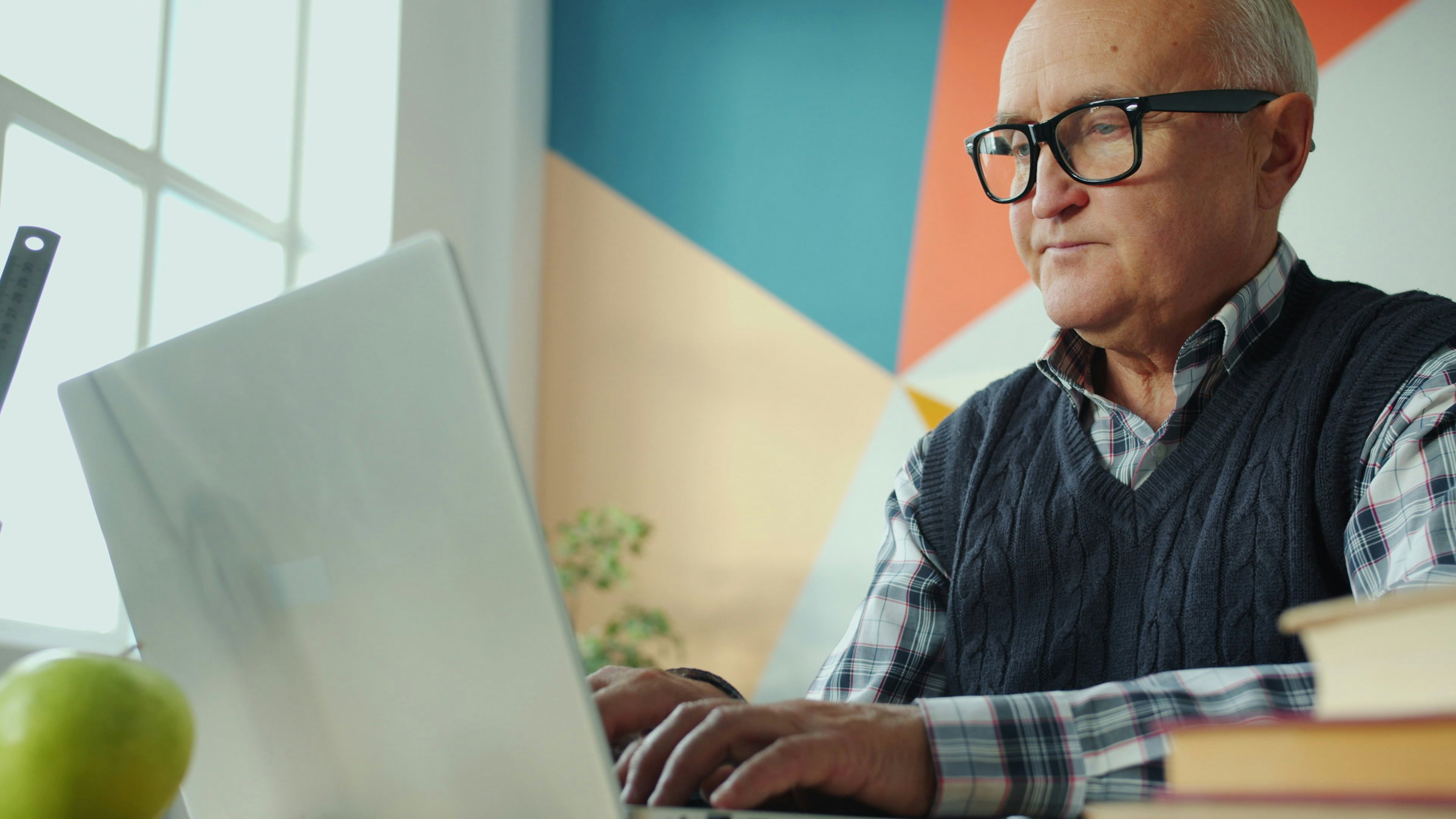 Senior adult smiling while learning to use a tablet